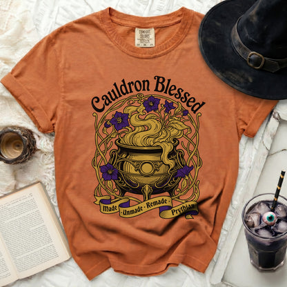 Orange Comfort Colors t-shirt with "Cauldron Blessed Made Unmade Remade Prythian" graphic.