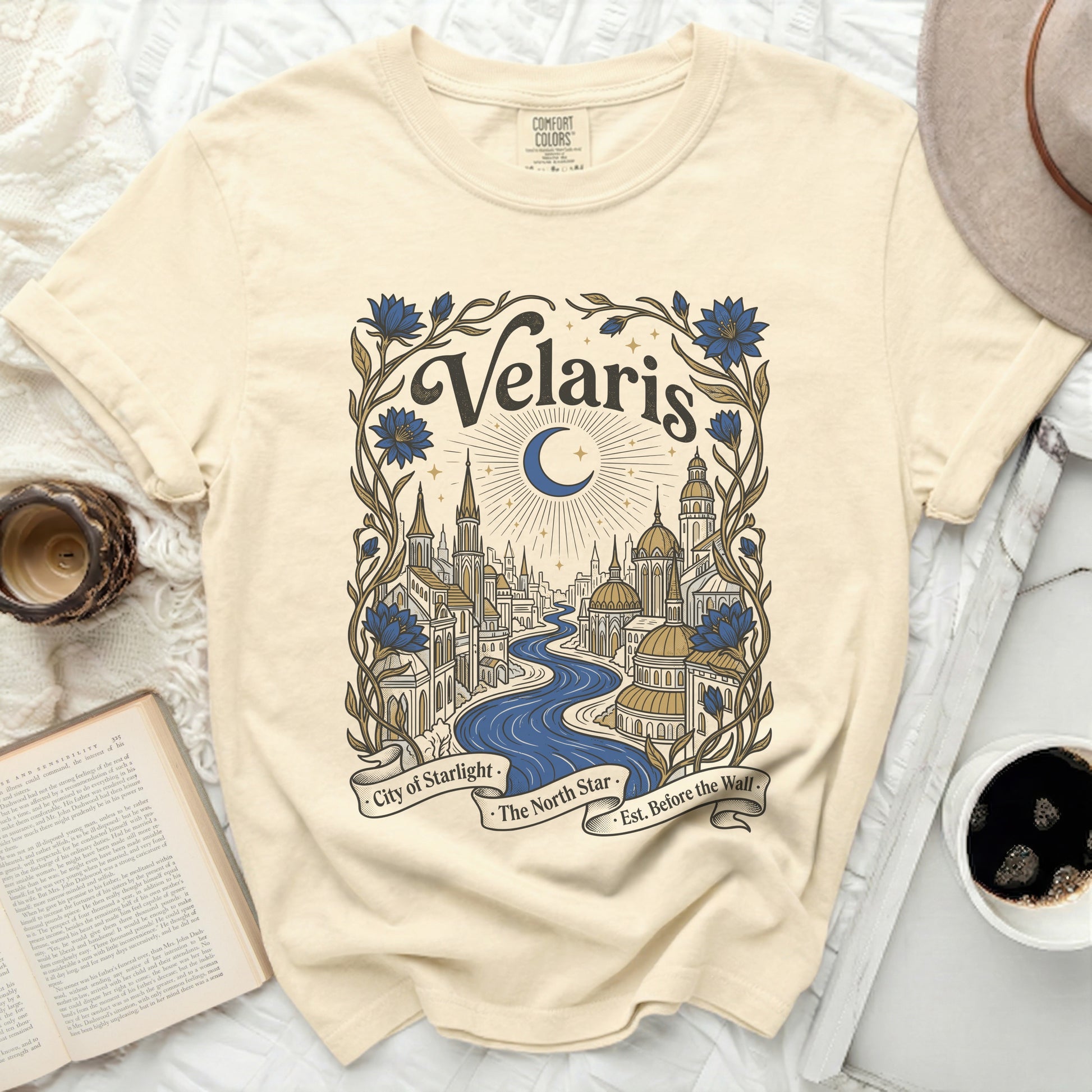Cream t-shirt with "Velaris City of Starlight" design featuring a moonlit city and floral accents.