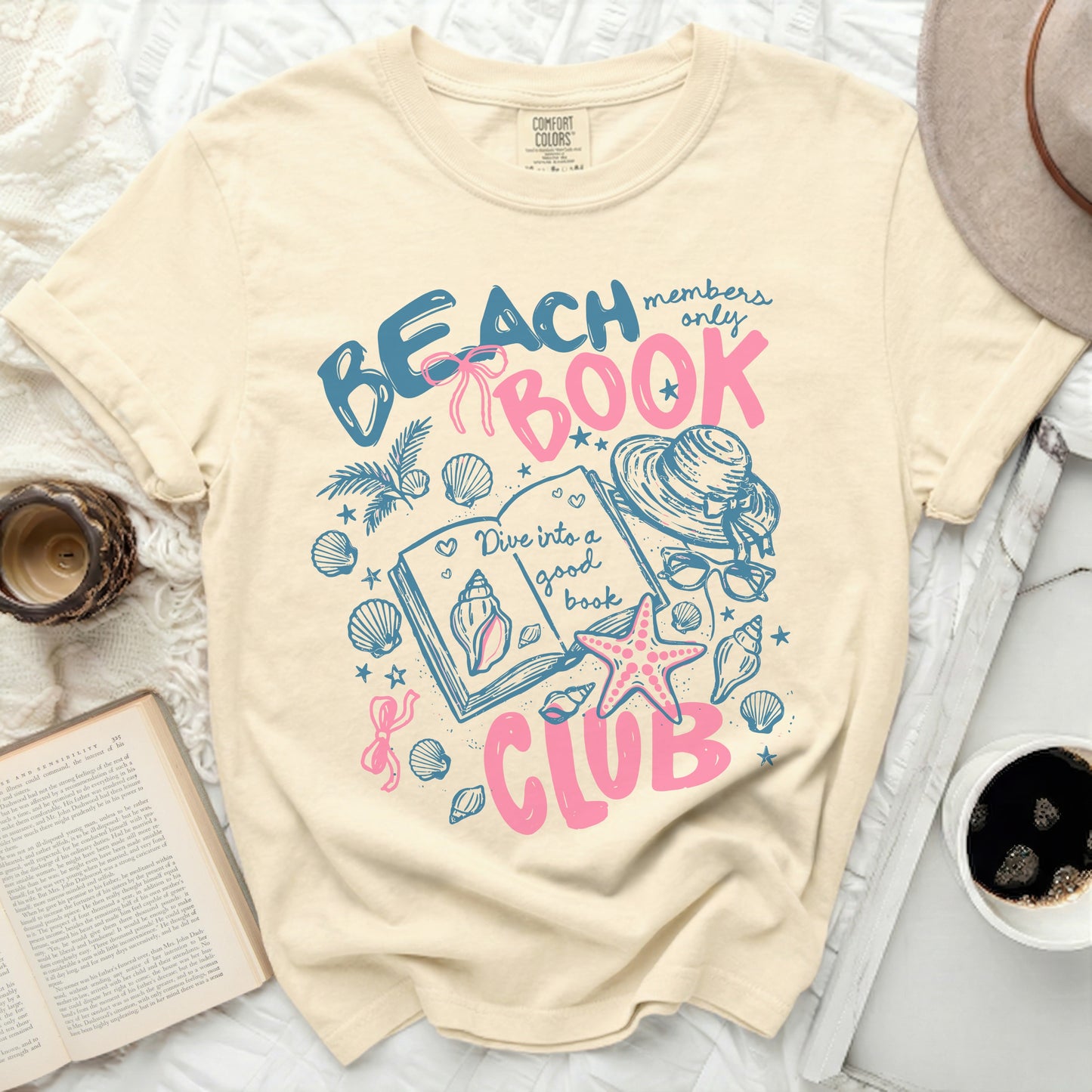 Beach Book Club graphic with seashells, sun hat, and open book.