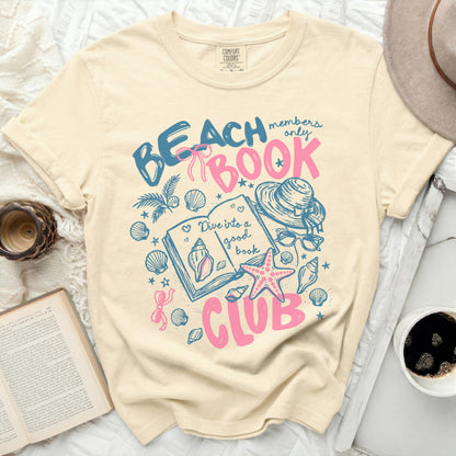 Beach Book Club graphic with seashells, sun hat, and open book.