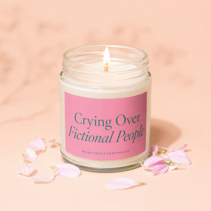 Candle with pink label reading "Crying Over Fictional People".