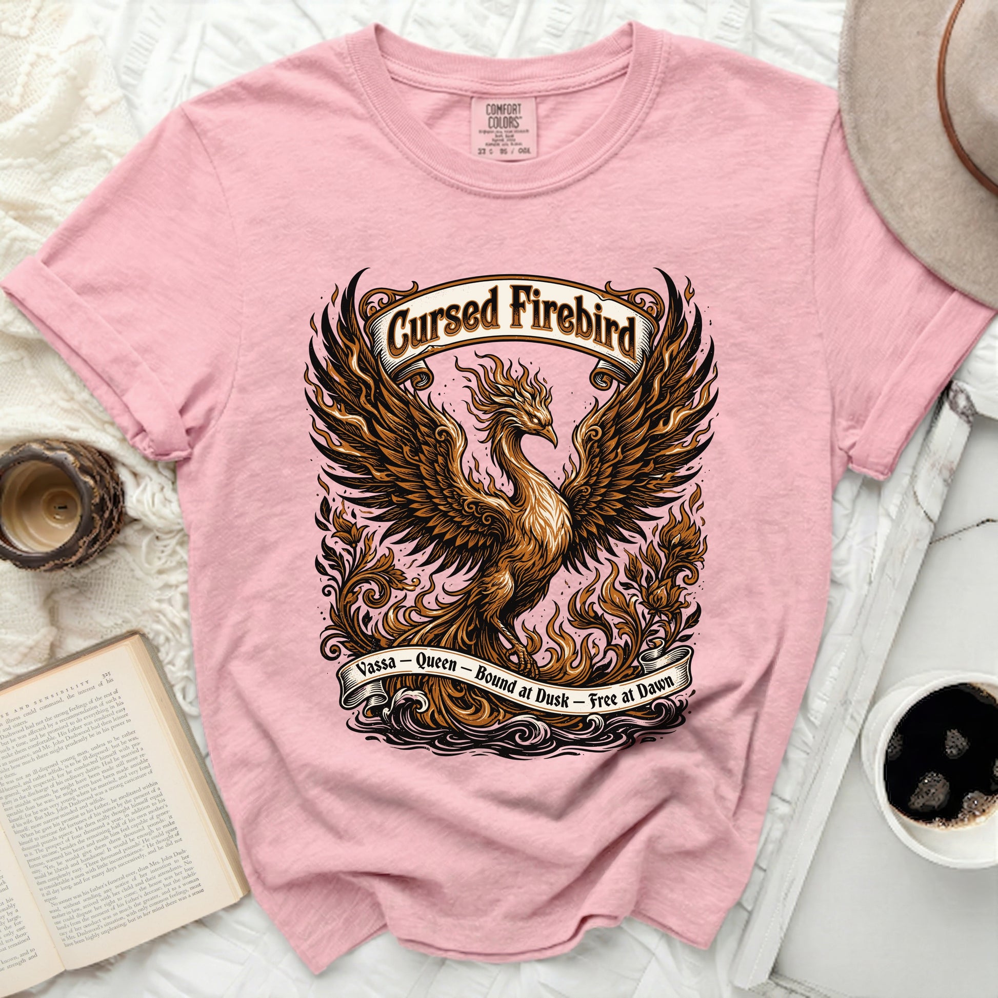 Pink t-shirt with a detailed illustration of a phoenix and flames.