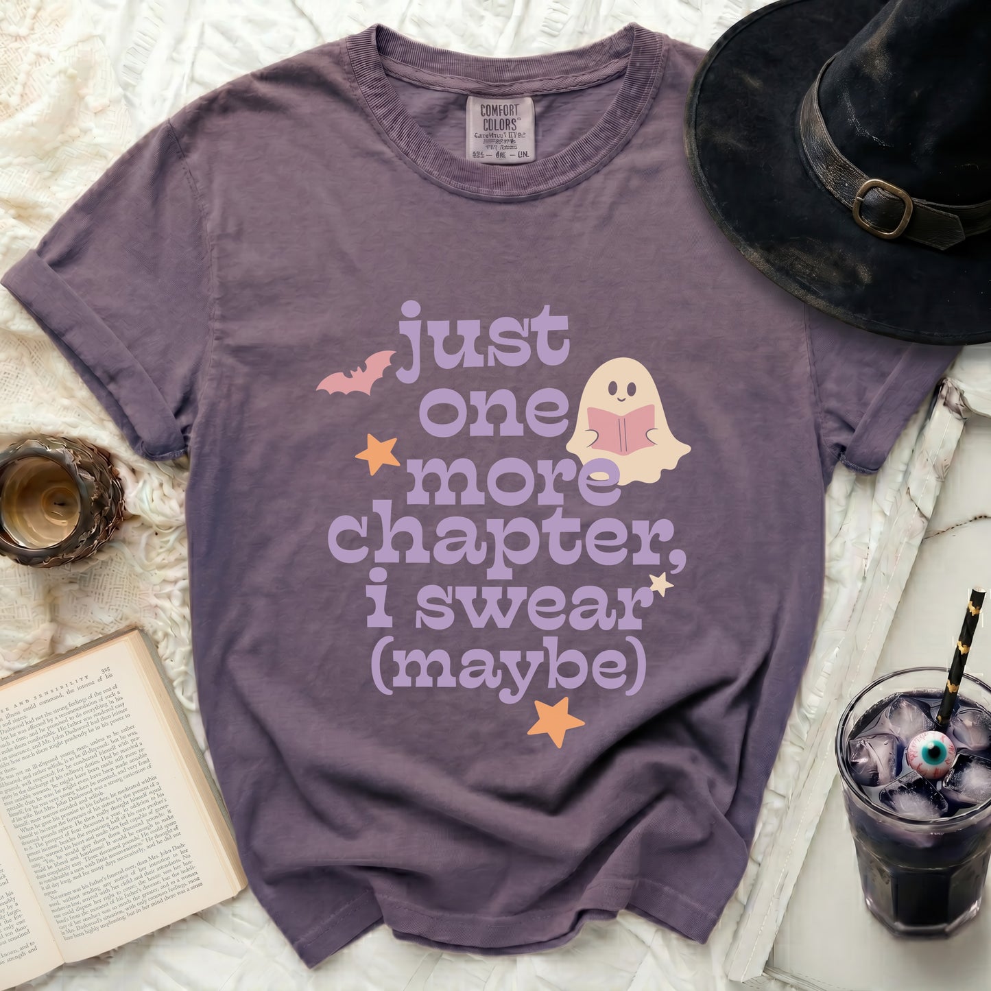 Purple t-shirt with ghost reading book and "Just one more chapter, I swear (maybe)" text.