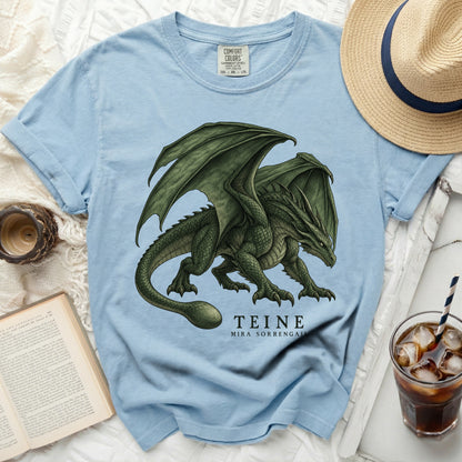 Light blue t-shirt with a green dragon illustration and "TEINE MIRA SORRENGAL" text.