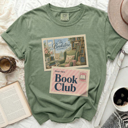 Olive green t-shirt with "The Bookstore" and "Always Open Book Club" graphic.