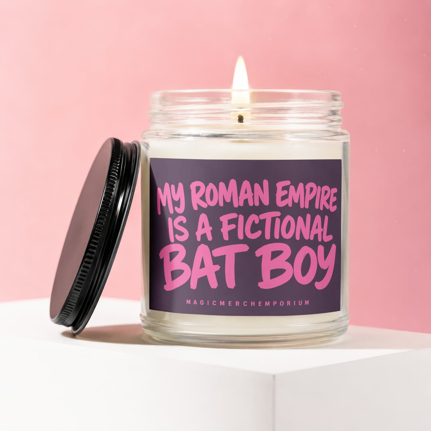 Jar candle with lit wick and black lid, text reads "My Roman Empire is a fictional Bat Boy".