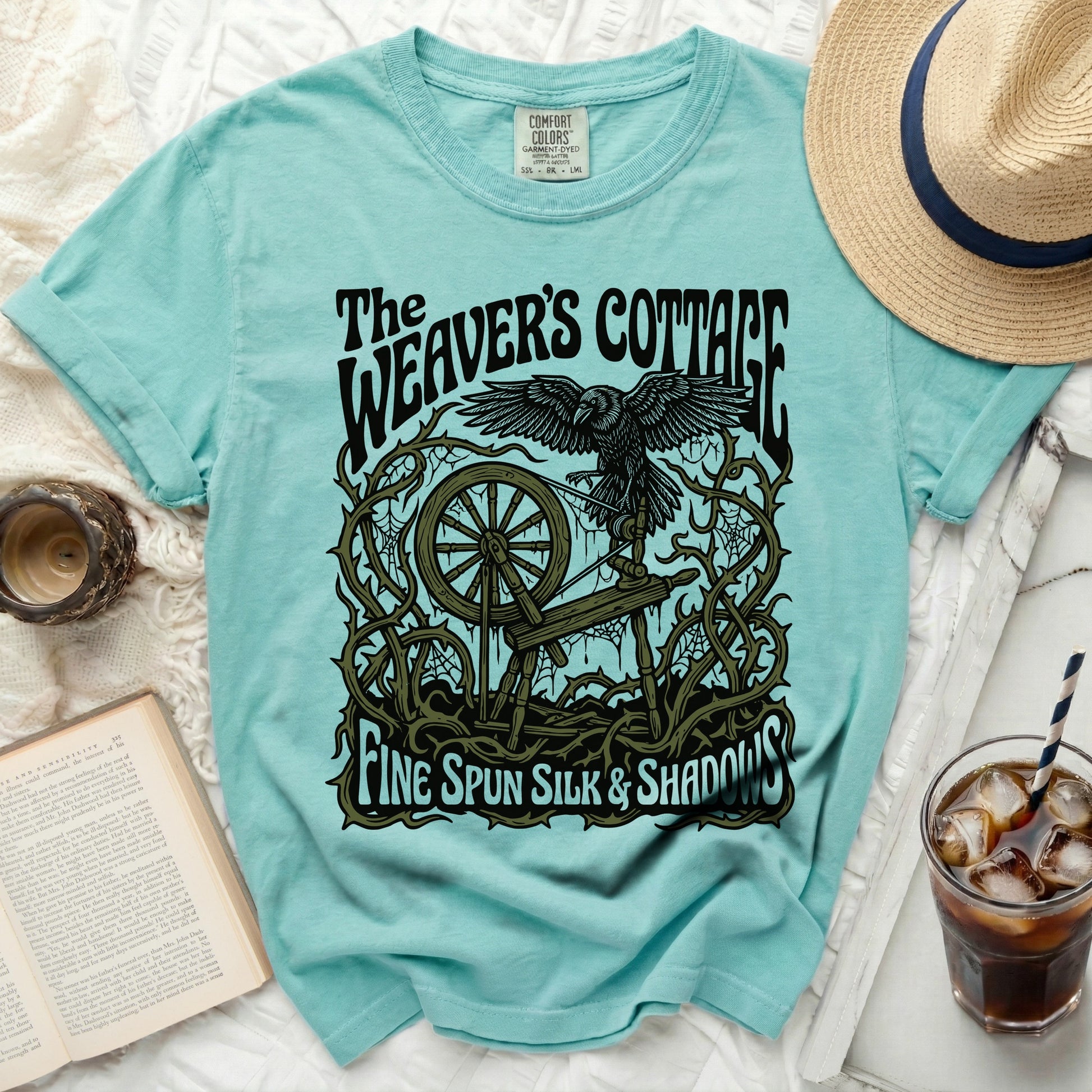 The Weaver's Cottage t-shirt with raven, spinning wheel, and text.