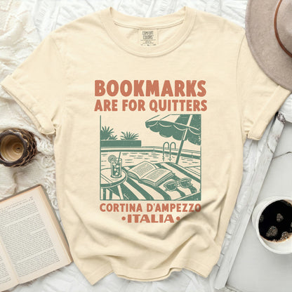 Cream t-shirt with "Bookmarked are for quitters" and Italy vacation graphic.