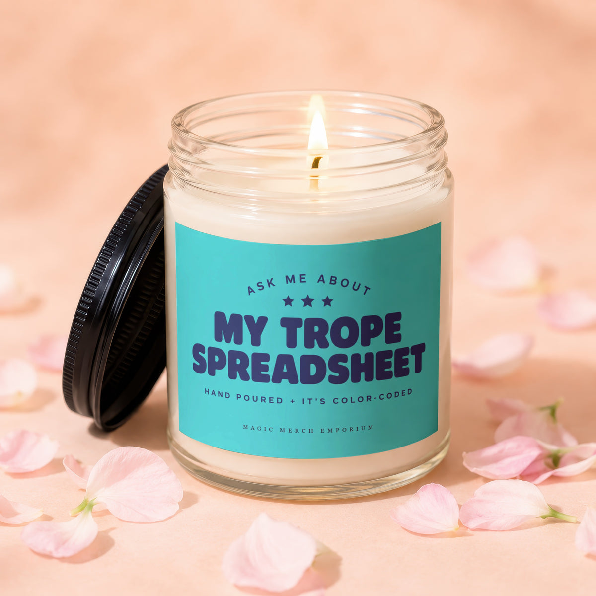 Jar candle with teal label that reads "My Trope Spreadsheet" and "Hand Poured + It's Color-Coded".