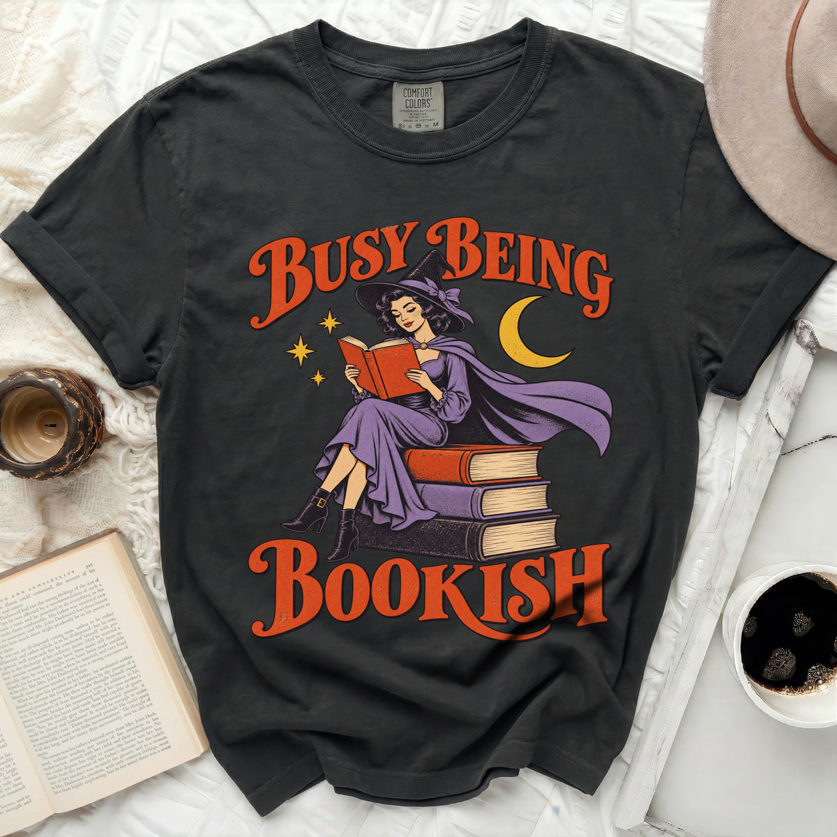 Dark grey t-shirt with vintage witch reading "Busy Being Bookish" graphic.