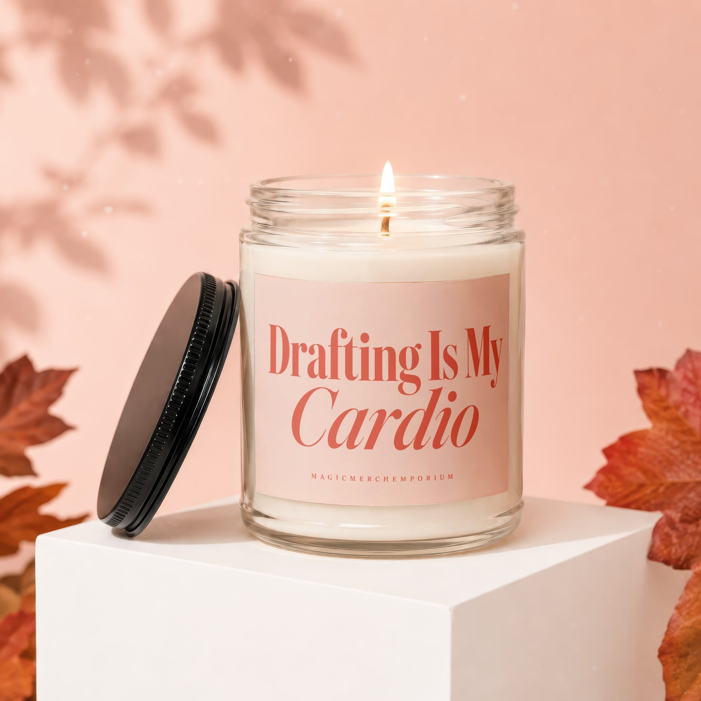 Jar candle with lid off, reading "Drafting Is My Cardio" on the label.