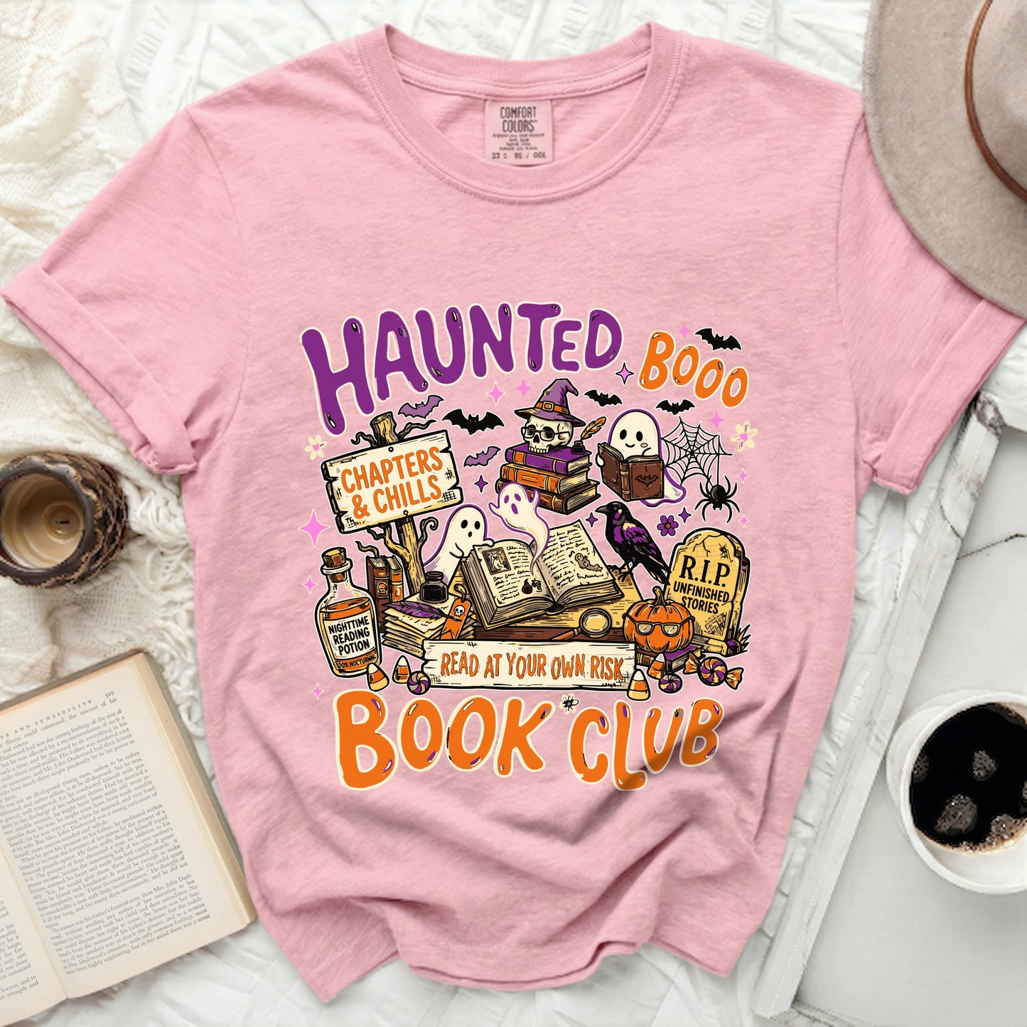 Pink t-shirt with "Haunted Book Club" Halloween graphics.