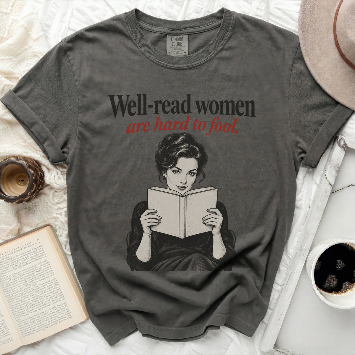 Gray t-shirt with graphic of a woman reading and text "Well-read women are hard to fool."