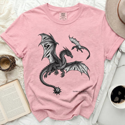 Pink t-shirt with black detailed dragon print and "TAIRN & SGAEYL" text.
