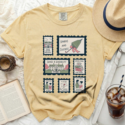 Yellow t-shirt with stamps featuring book titles: Pride and Prejudice, Sparks and Silence, Sense & Sensibility.