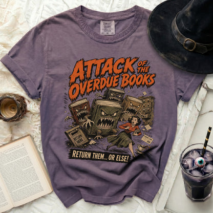 Purple t-shirt with "Attack of the Overdue Books" Halloween graphic.