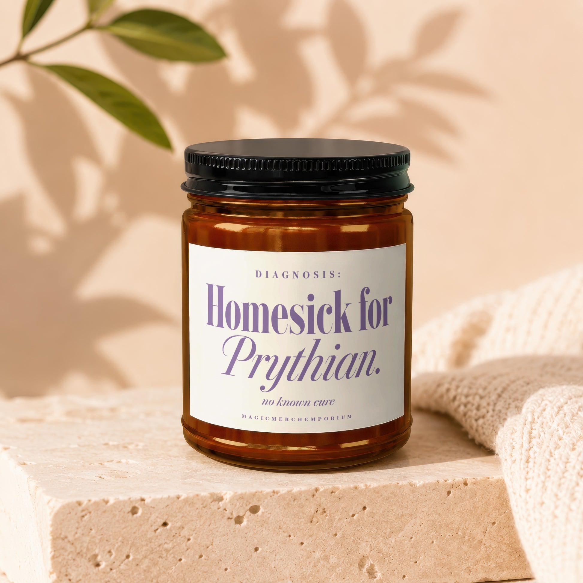 Brown glass candle with white label text "Homesick for Prythian. no known cure".