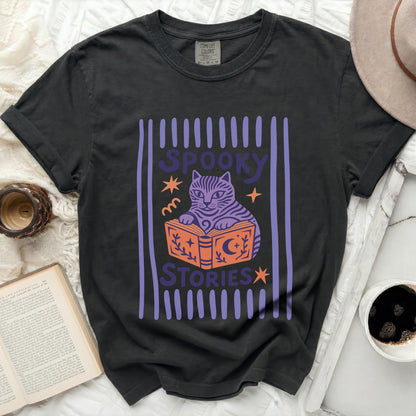 Black t-shirt with a purple cat reading a book with "Spooky Stories" text.