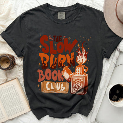 T-shirt with "The Slow Burn" text, lighter, and books graphic.