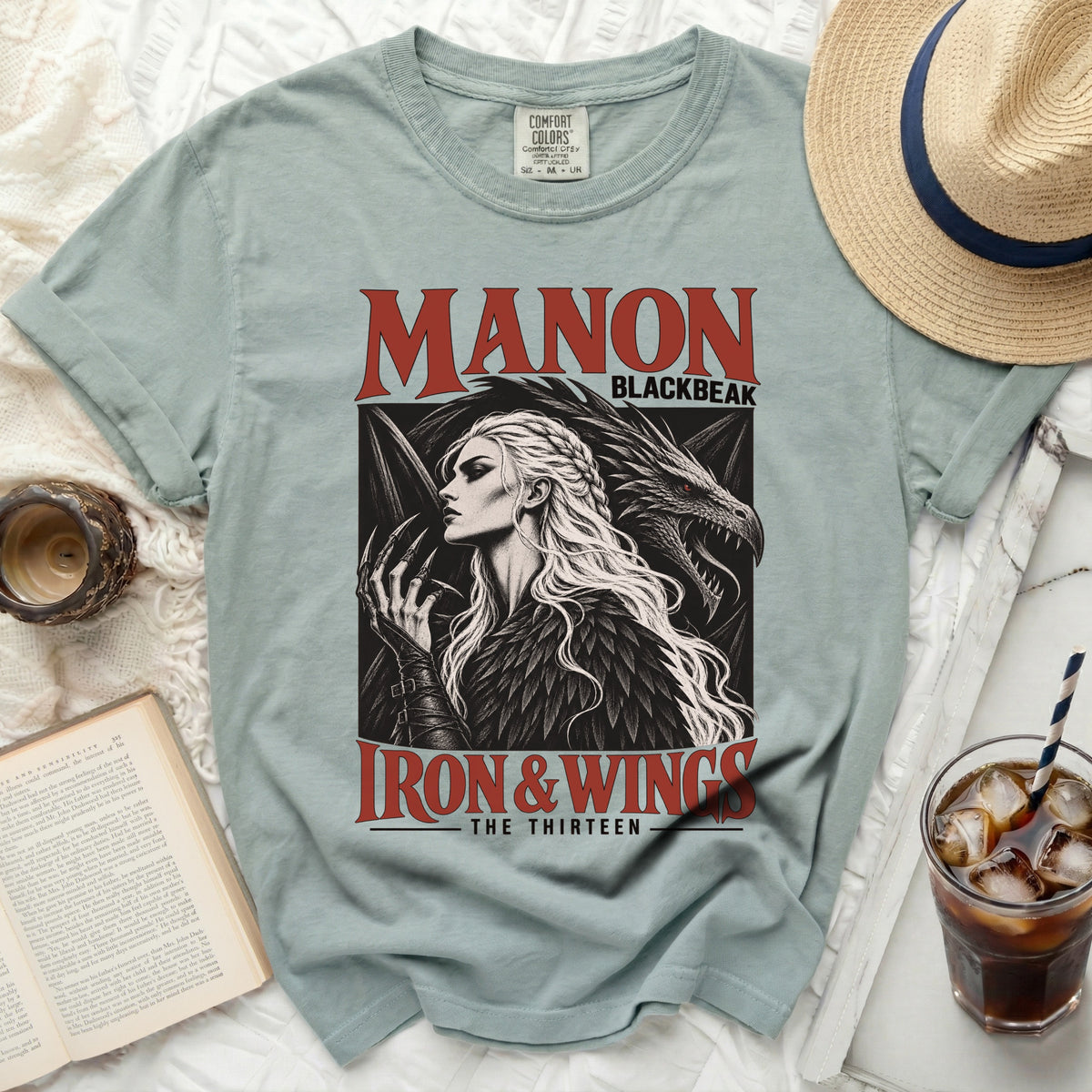 T-shirt with graphic of Manon Blackbeak, a dragon, and text "Iron & Wings - The Thirteen".