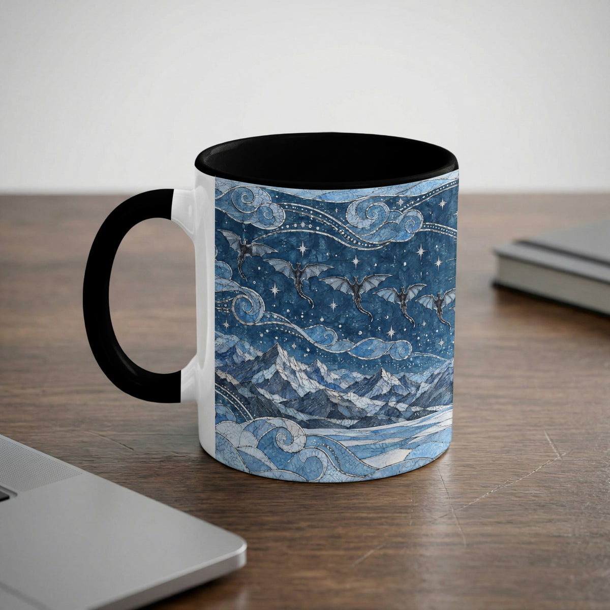 A white ceramic mug with a black rim and handle, featuring a blue fantasy landscape illustration with dragons flying over mountains and a starry sky.