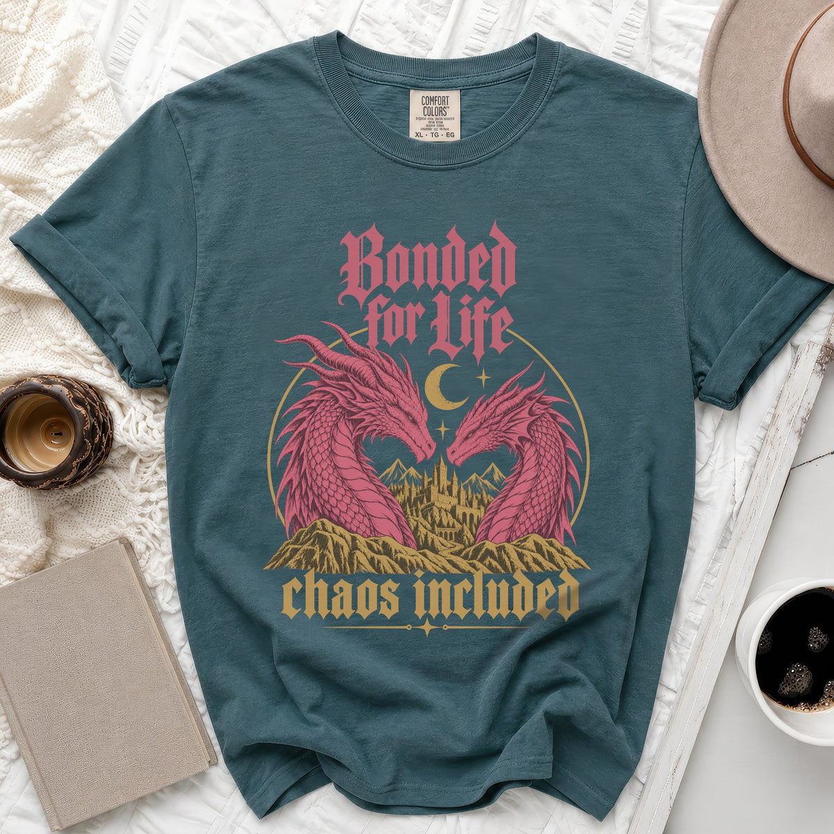 Teal t-shirt with pink dragons, castle, moon, and text: "Bonded for Life chaos included".