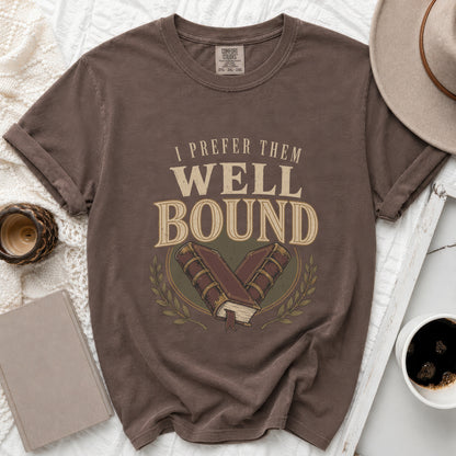 Brown t-shirt with "I PREFER THEM WELL BOUND" and an illustration of two books.