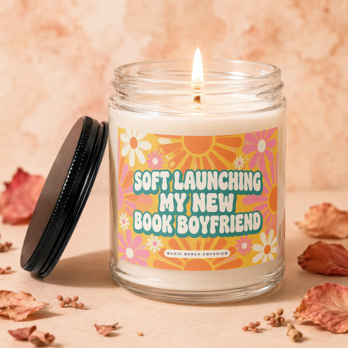 Lit candle in glass jar with lid off, reading "Soft Launching My New Book Boyfriend".