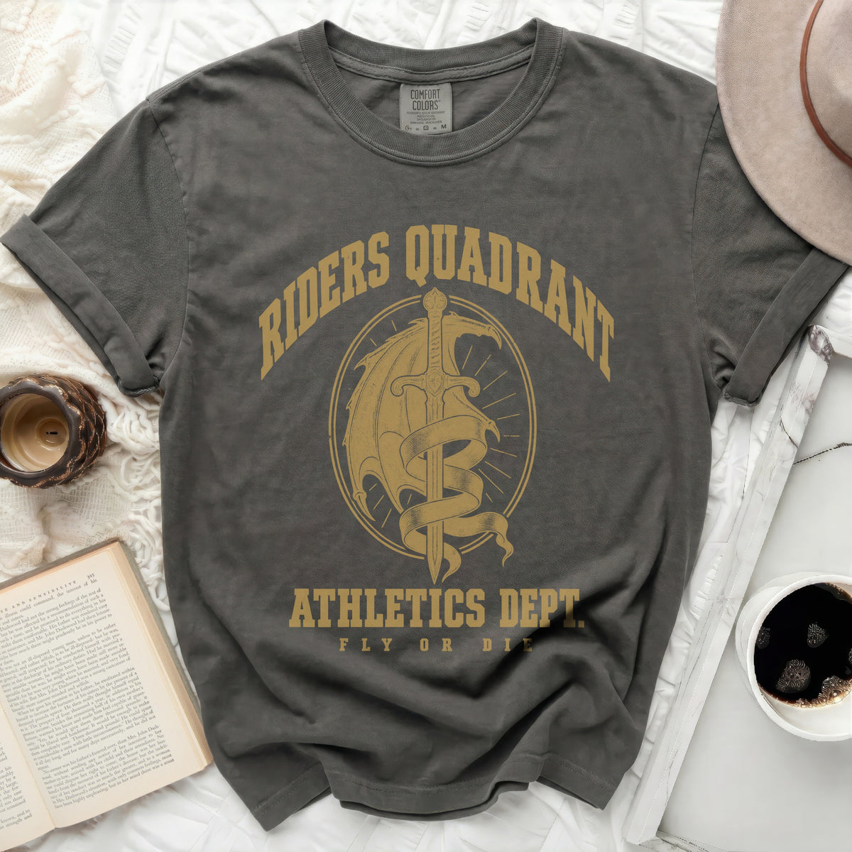 Dark gray t-shirt with gold graphic reading Riders Quadrant Athletics Dept Fly or Die.