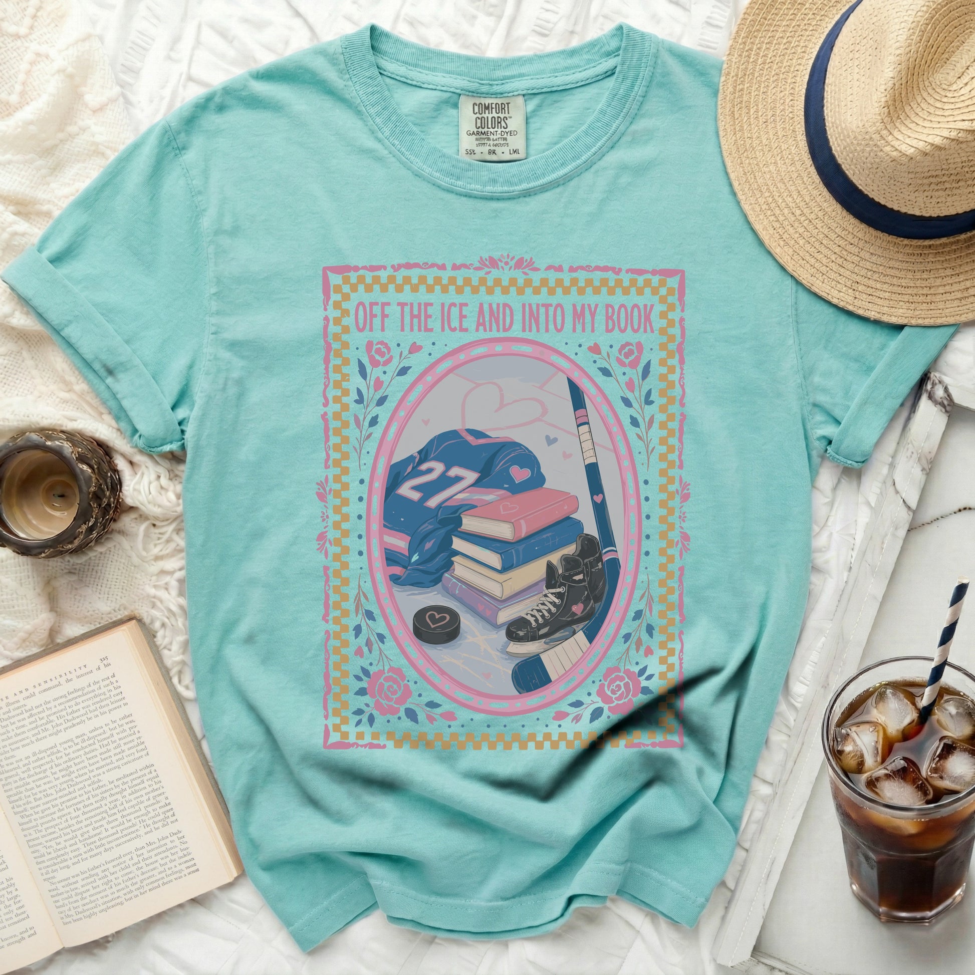 Turquoise t-shirt with "Off the Ice and Into My Book" and hockey gear.