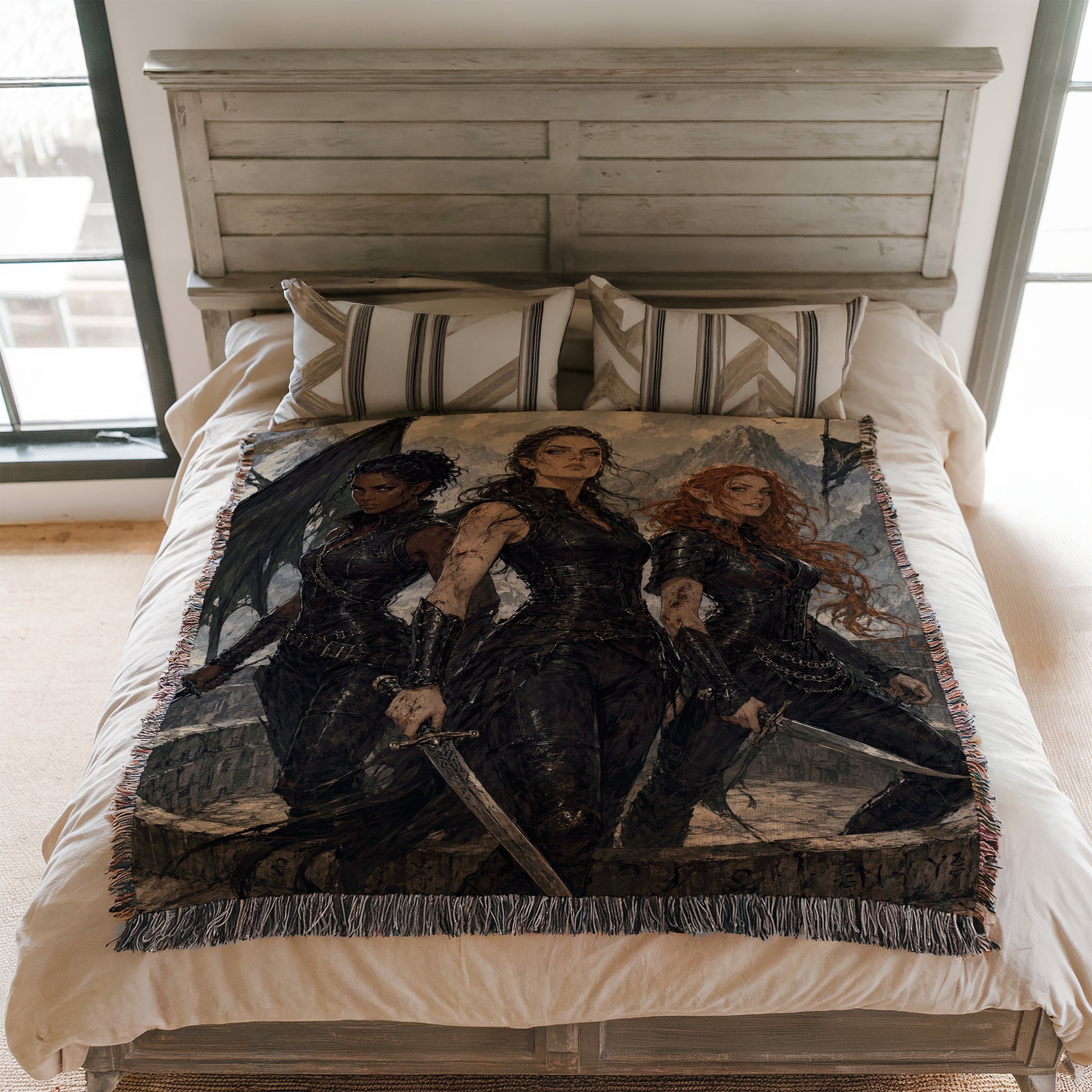 a bed with a large blanket that depicts three women in black outfits, each holding a sword.