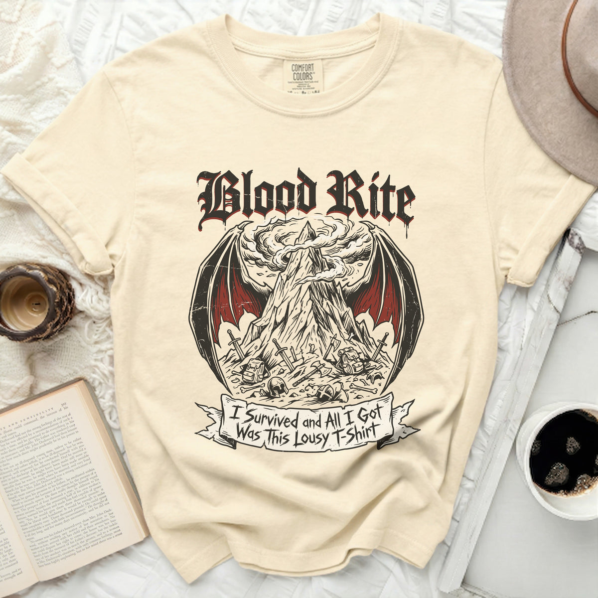 Cream t-shirt with "Blood Rite" graphic and "I Survived and All I Got Was This Lousy T-Shirt" text.