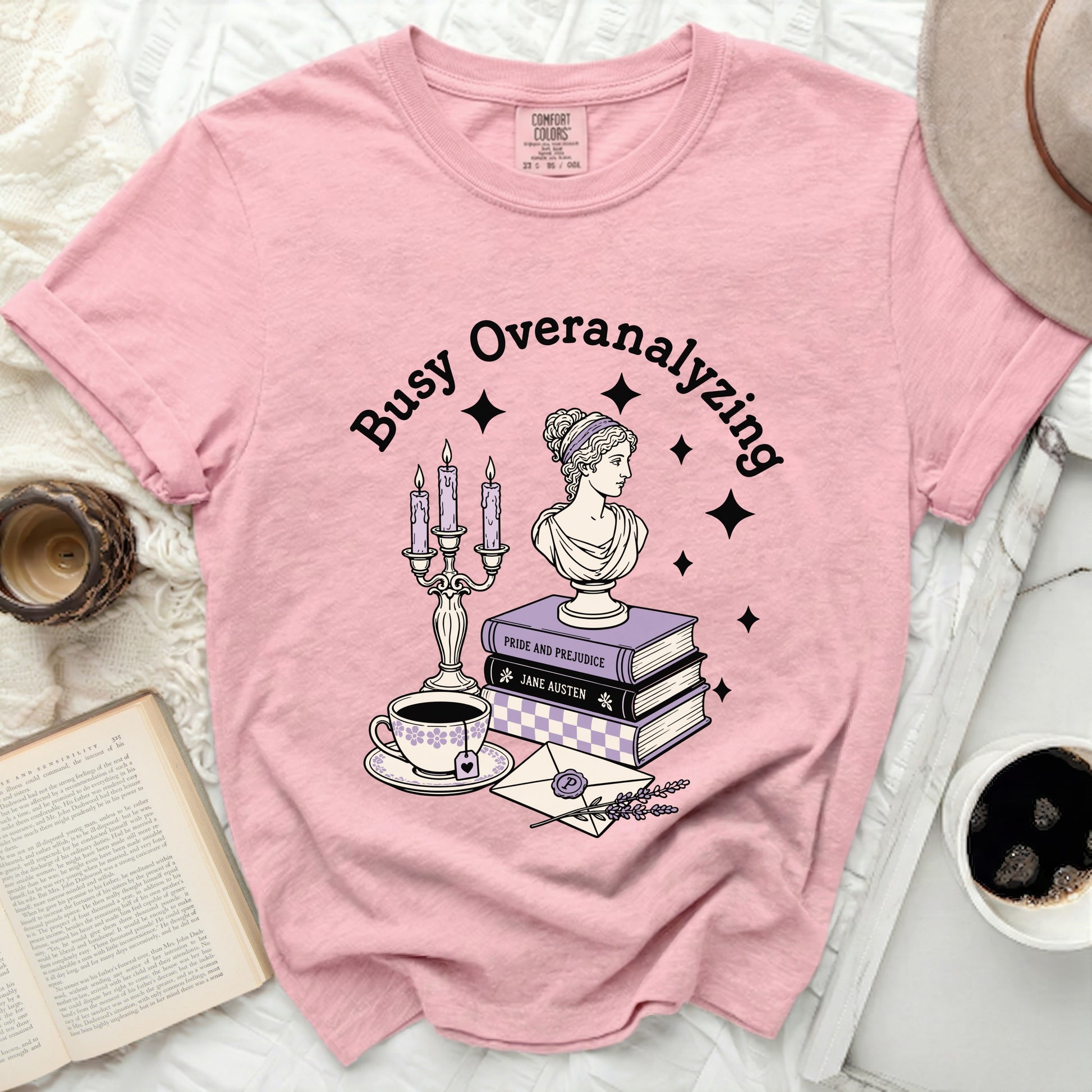 Pink t-shirt with "Busy Overanalyzing" graphic and literary elements.