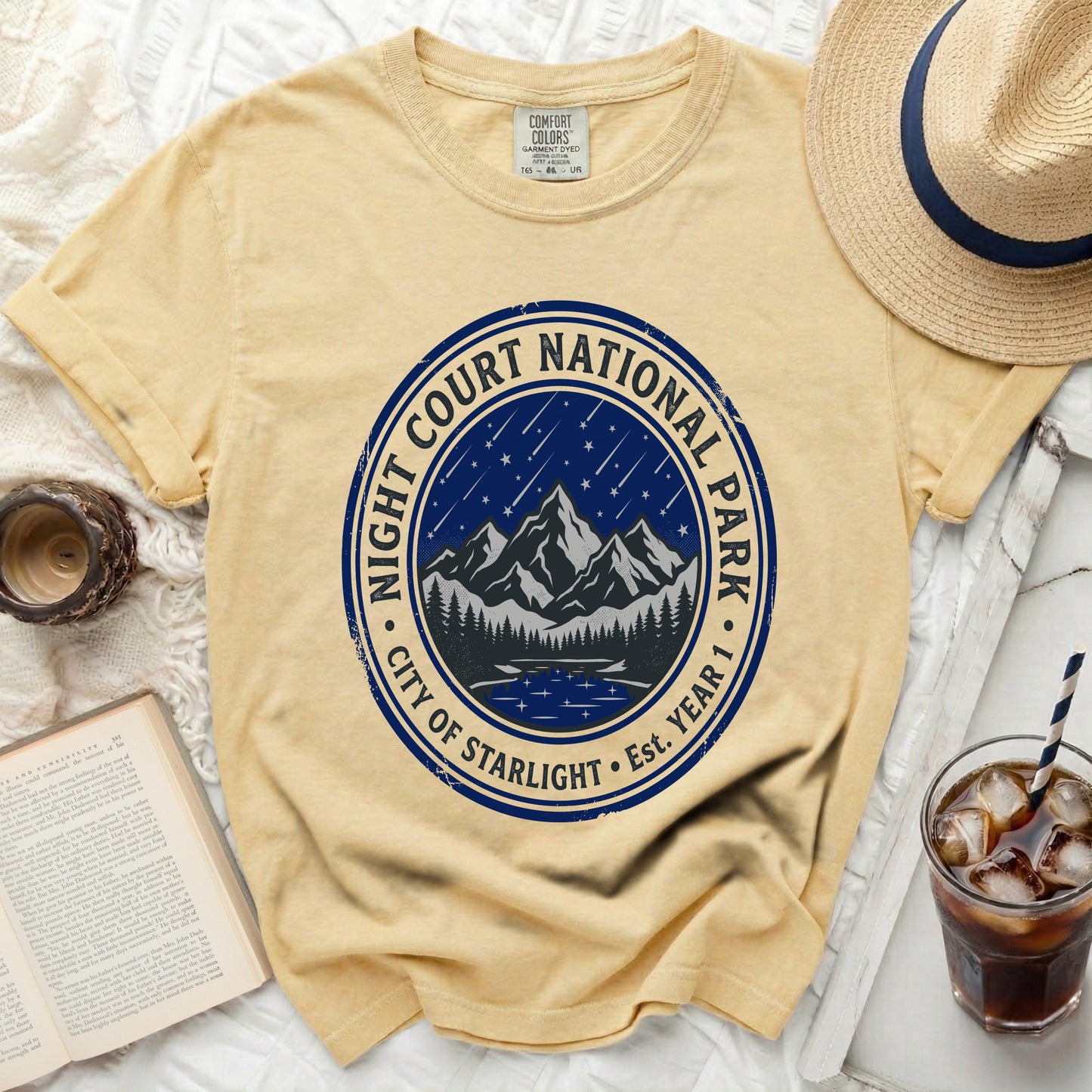 Yellow t-shirt with "Night Court National Park City of Starlight" graphic.