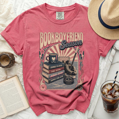 T-shirt graphic with "Bookboyfriend Season" text, hockey puck, skates, and coffee cup.