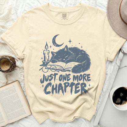 Cream t-shirt with "Just One More Chapter" and sleeping cat graphic.
