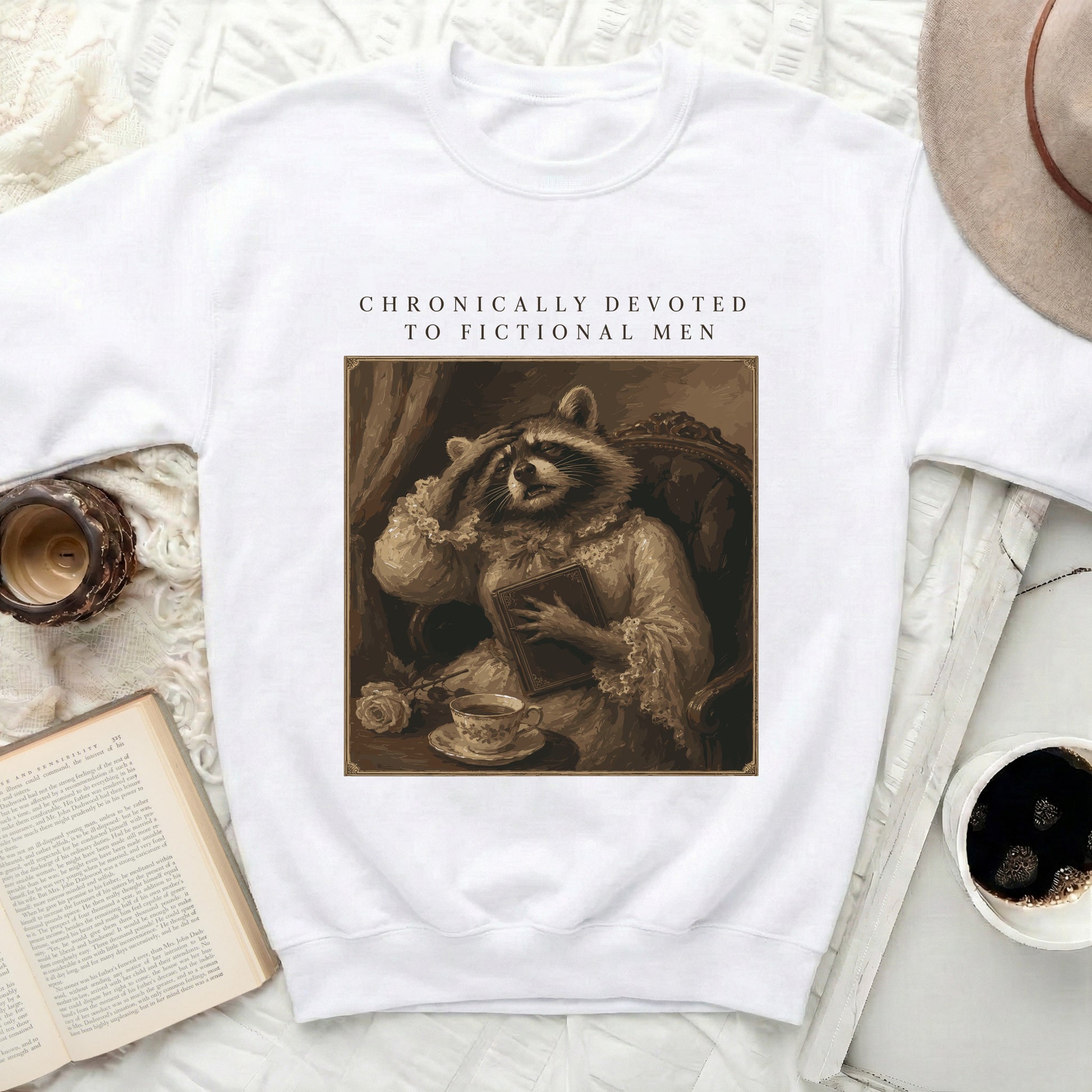 Crewneck sweatshirt with raccoon in Victorian attire and text "CHRONICALLY DEVOTED TO FICTIONAL MEN".