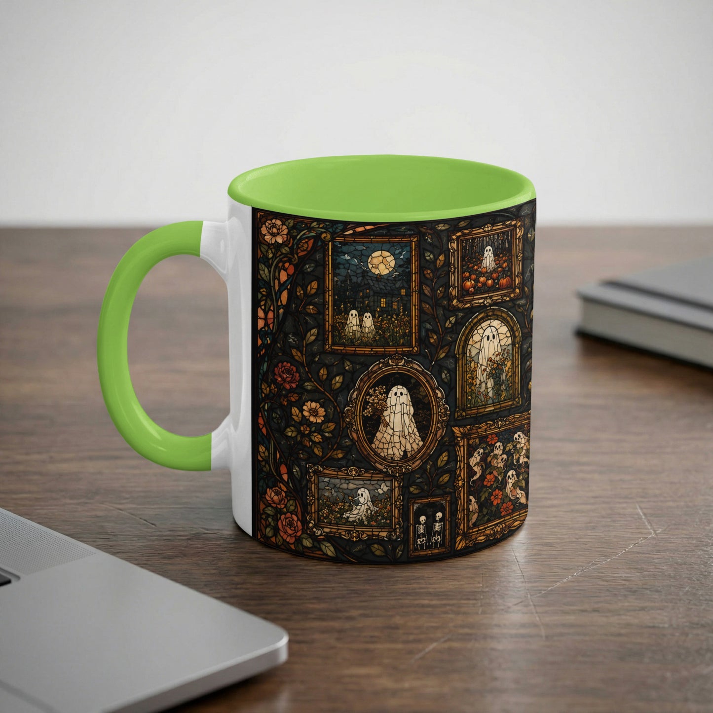 White mug with green handle and rim, decorated with stained-glass ghosts and skeletons.