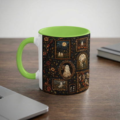 White mug with green handle and rim, decorated with stained-glass ghosts and skeletons.