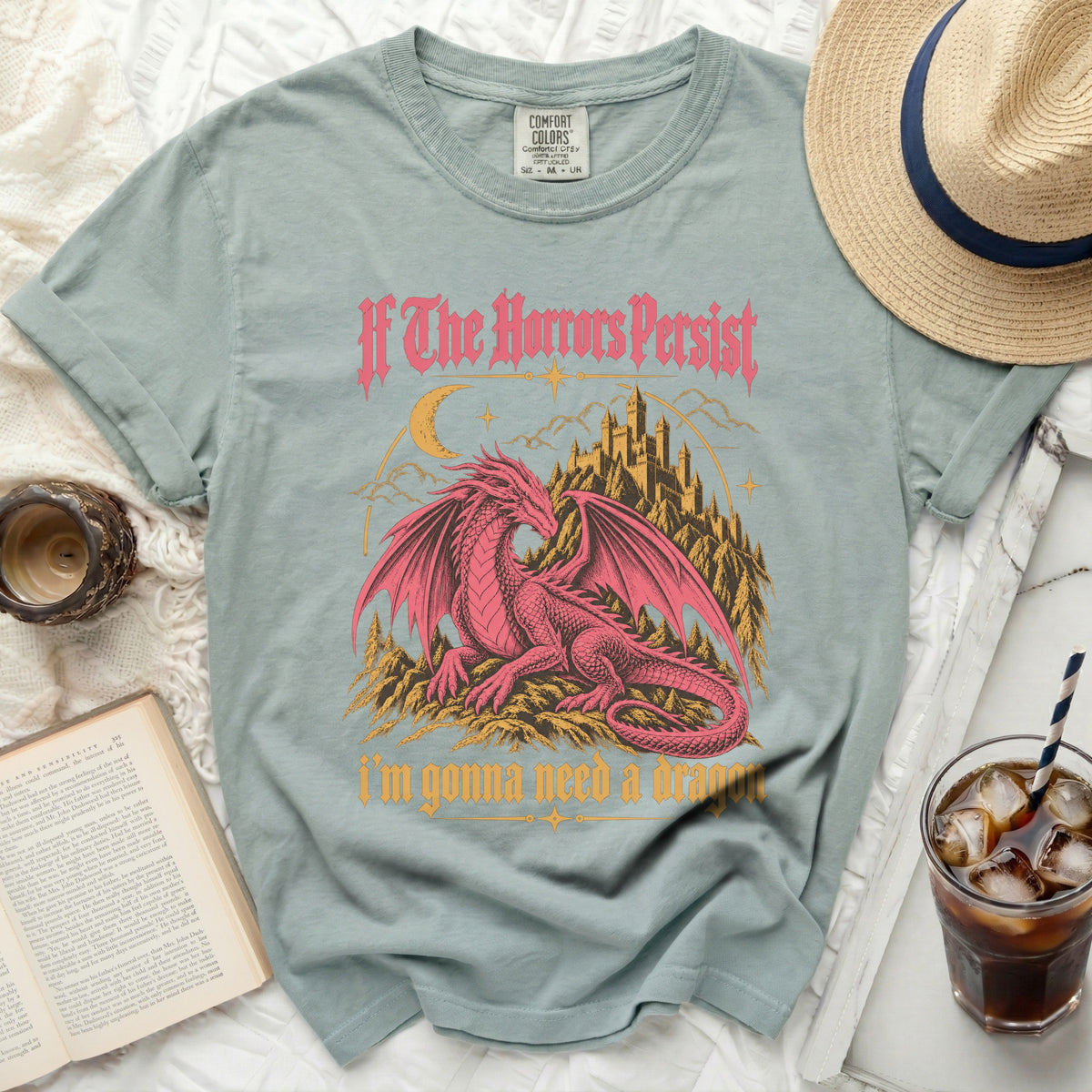 Light blue t-shirt with pink dragon and castle graphic, text "If The Horrors Persist i'm gonna need a dragon".