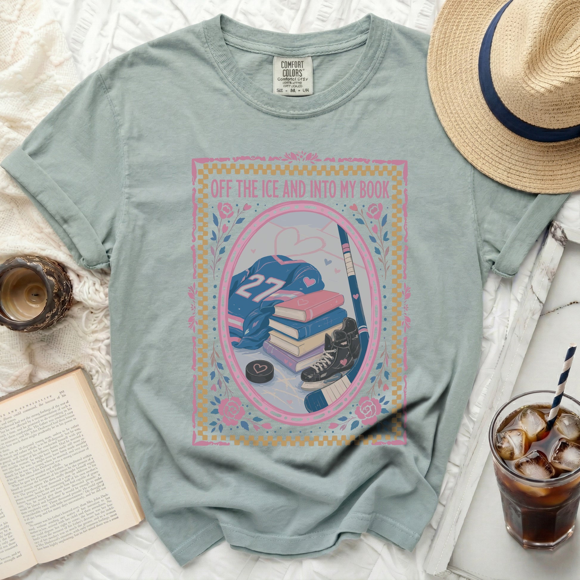 Light blue t-shirt with "Off the Ice and Into My Book" and hockey graphic.
