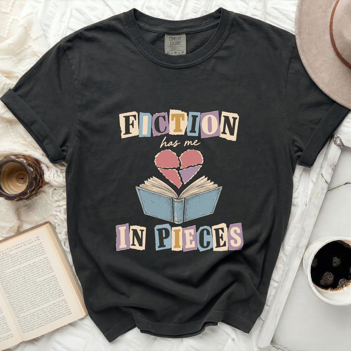 Dark t-shirt with "Fiction has me in pieces" graphic and broken heart.