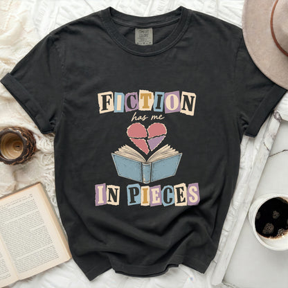 Dark t-shirt with "Fiction has me in pieces" graphic and broken heart.