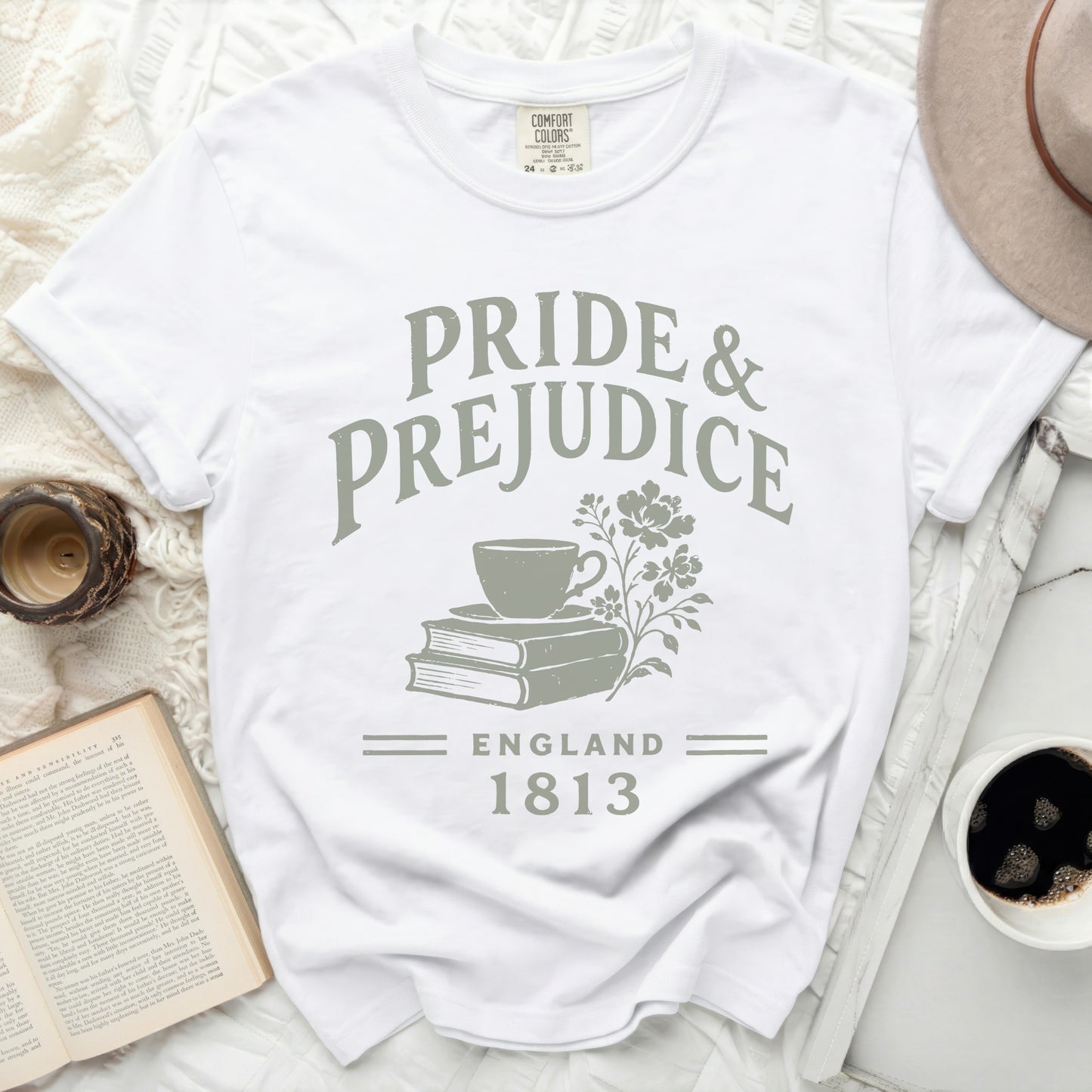 White t-shirt with "Pride & Prejudice England 1813" text and teacup on books graphic.