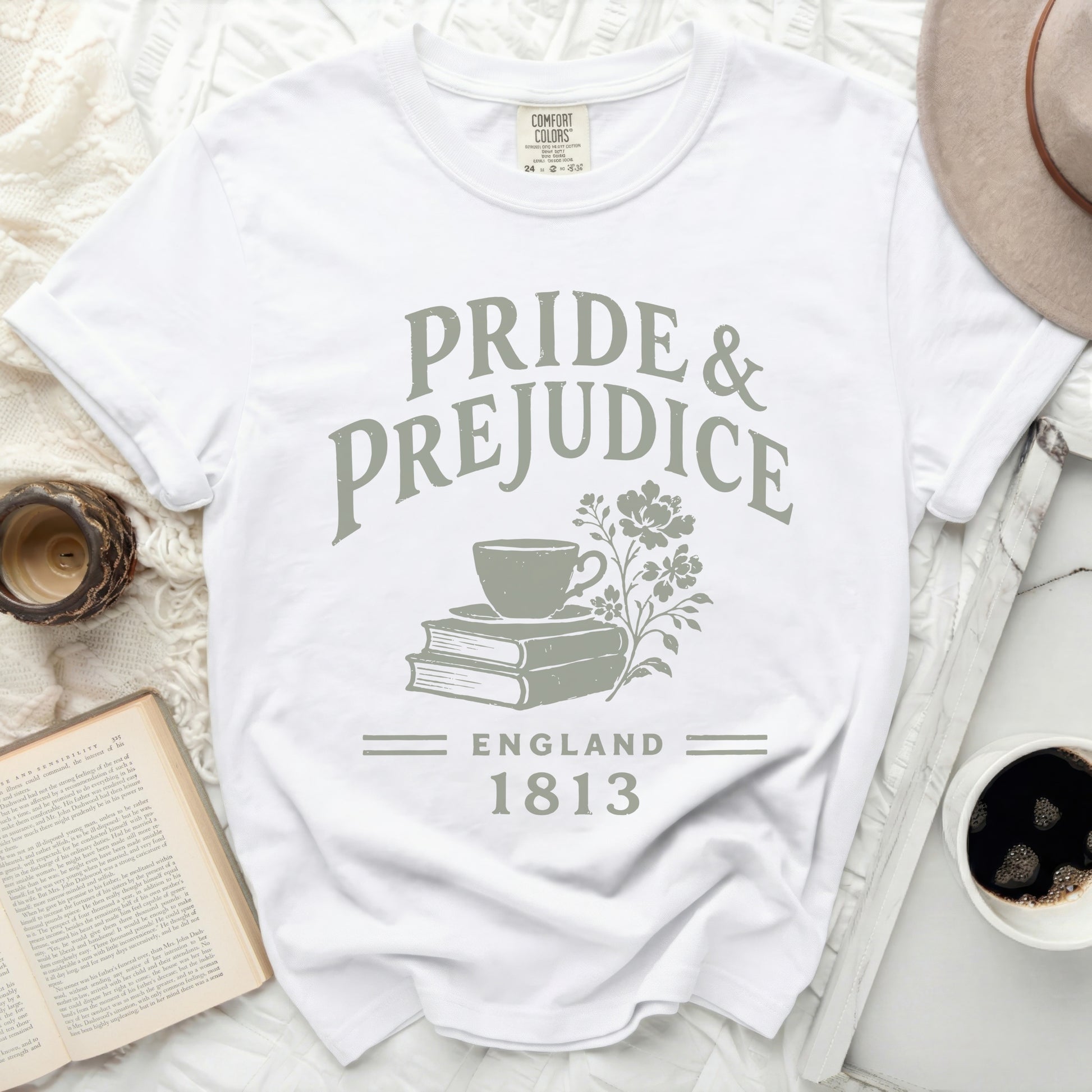 White t-shirt with "Pride & Prejudice England 1813" text and teacup on books graphic.