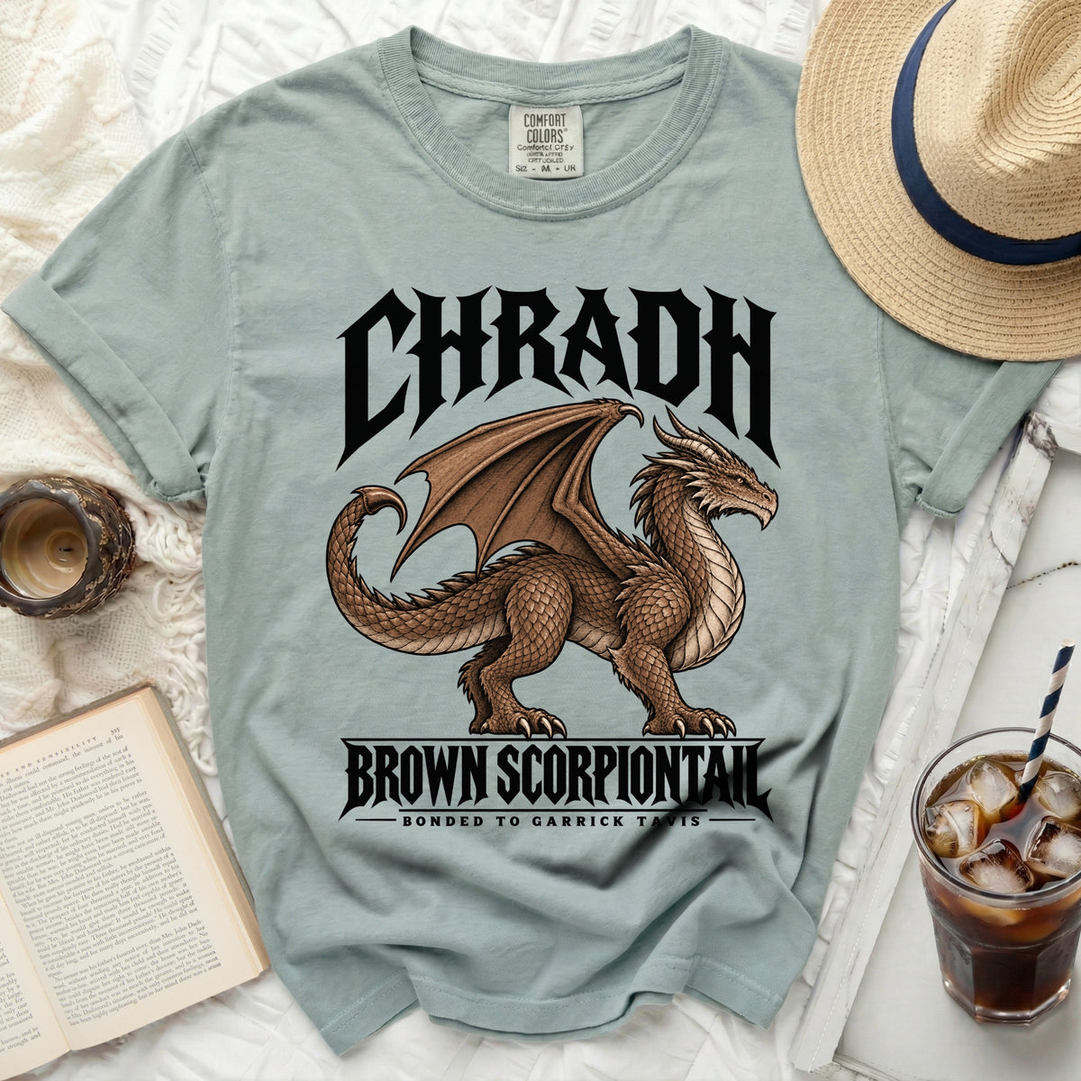 Light blue t-shirt with a brown dragon graphic and text "CHRADH BROWN SCORPIONTAIL".