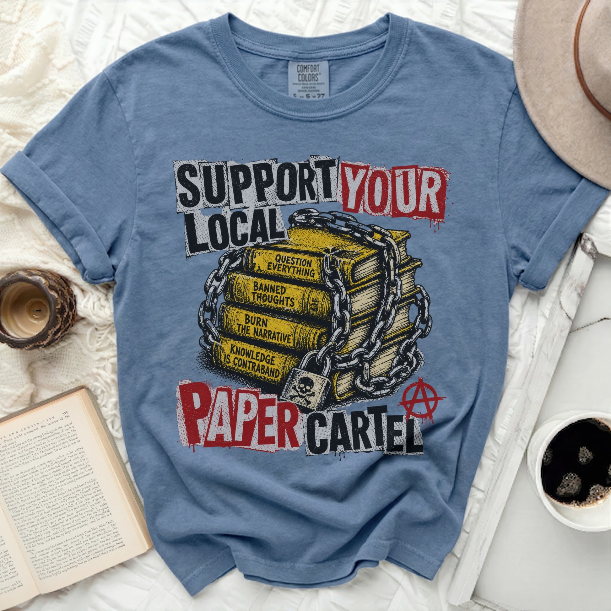 Shirt with "Support Your Paper Cartel" text and stacked books.