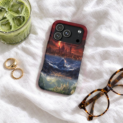 A smartphone case featuring a fantasy landscape design lies on a textured white sheet beside glasses, rings, and iced green tea.