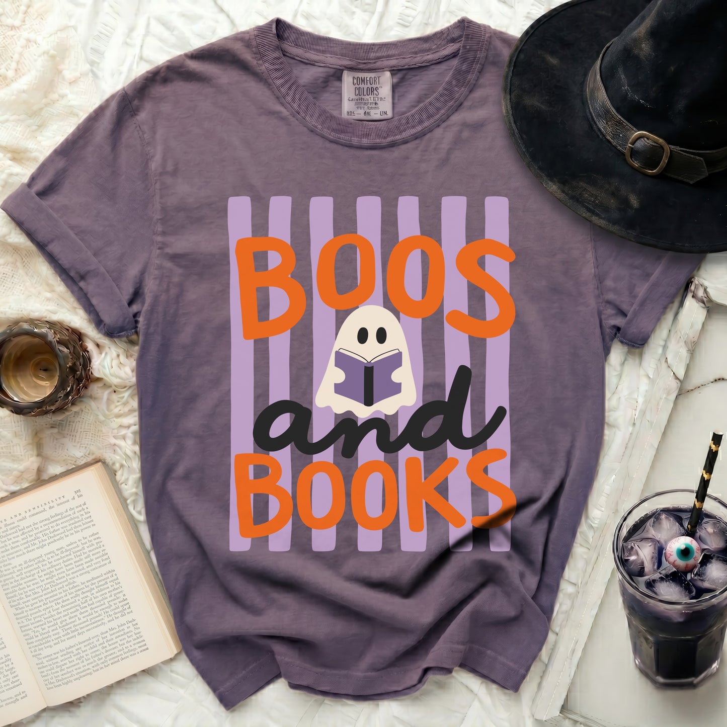 Purple t-shirt with "Boos and Books" Halloween ghost graphic.