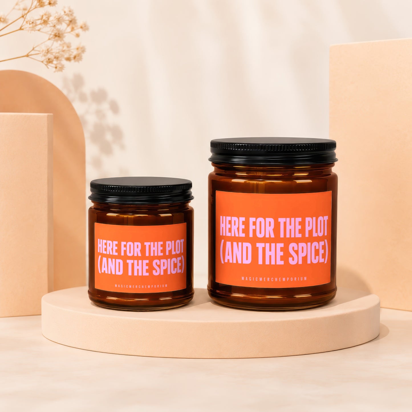 Amber candles with orange labels saying "HERE FOR THE PLOT (AND THE SPICE)".